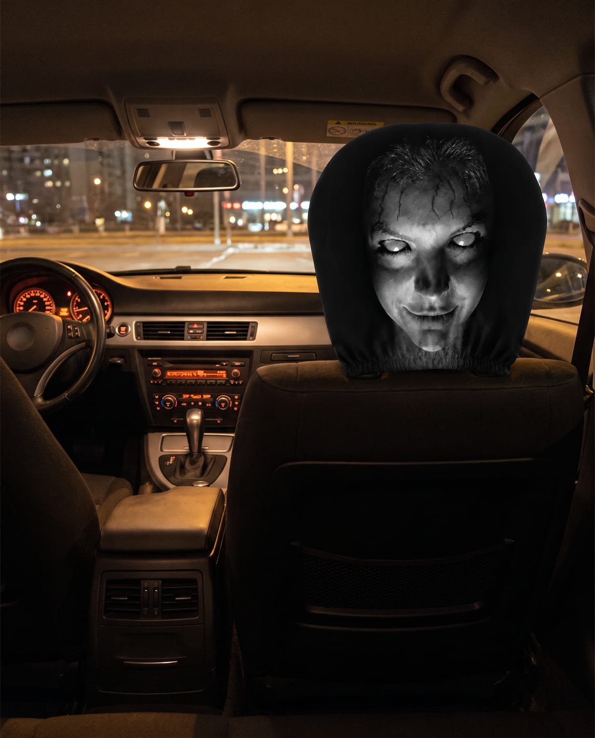 Pokrowiec Lumaween na zagłówku przedniego fotela, widok z tylnej kanapy nocą